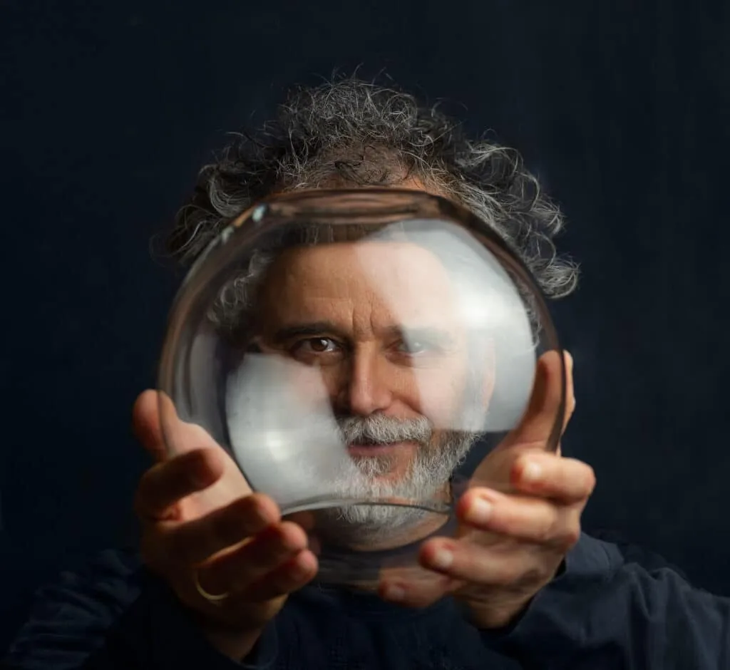 Creative strategist looking through a glass sphere